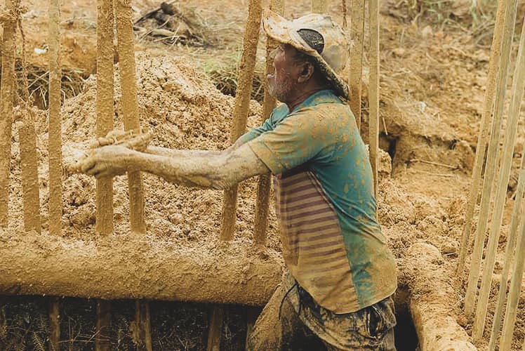 A gem dealer examining rough Ceylon sapphires